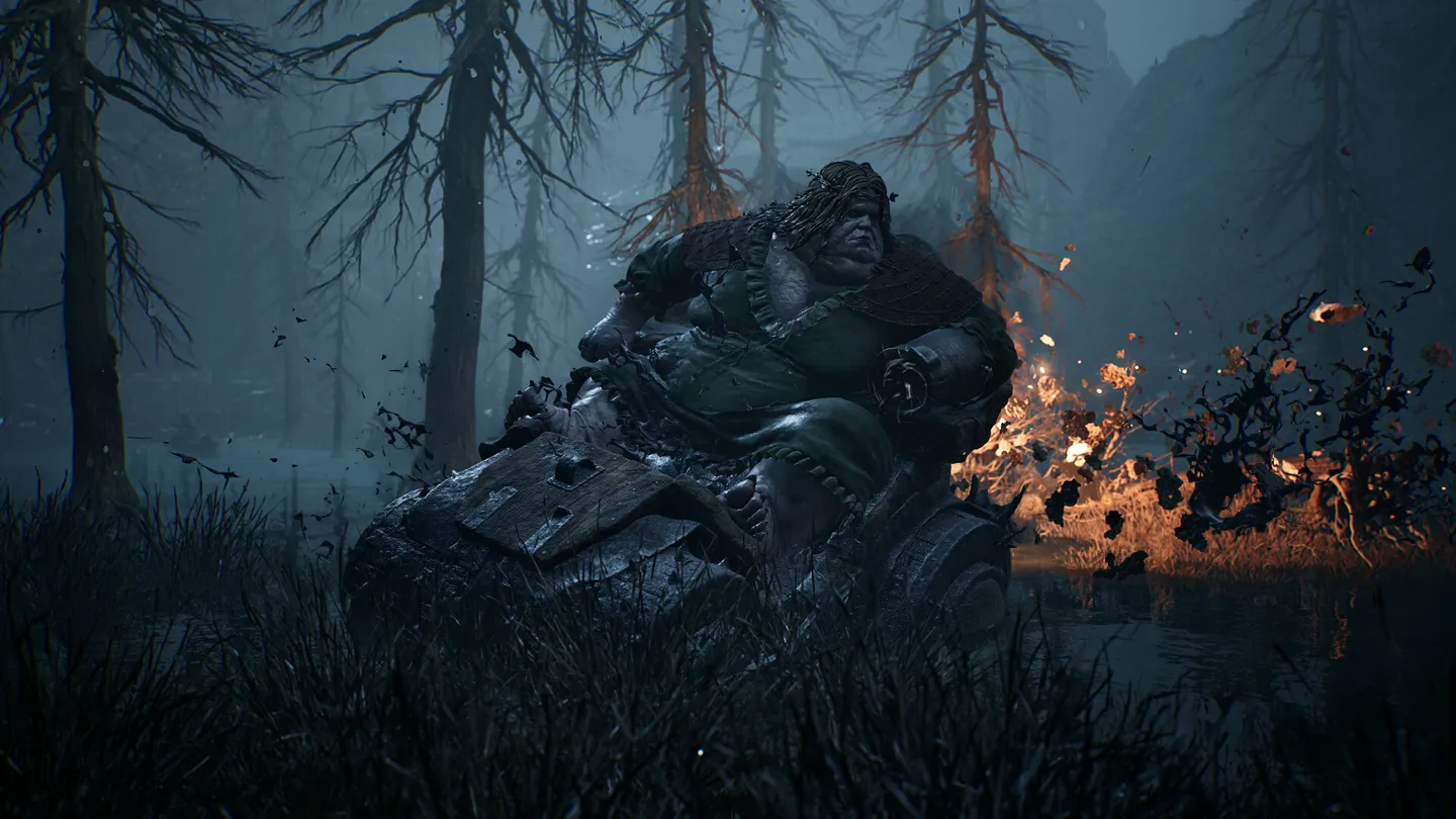 A towering creature in a burning blue forest in Mortal Shell II